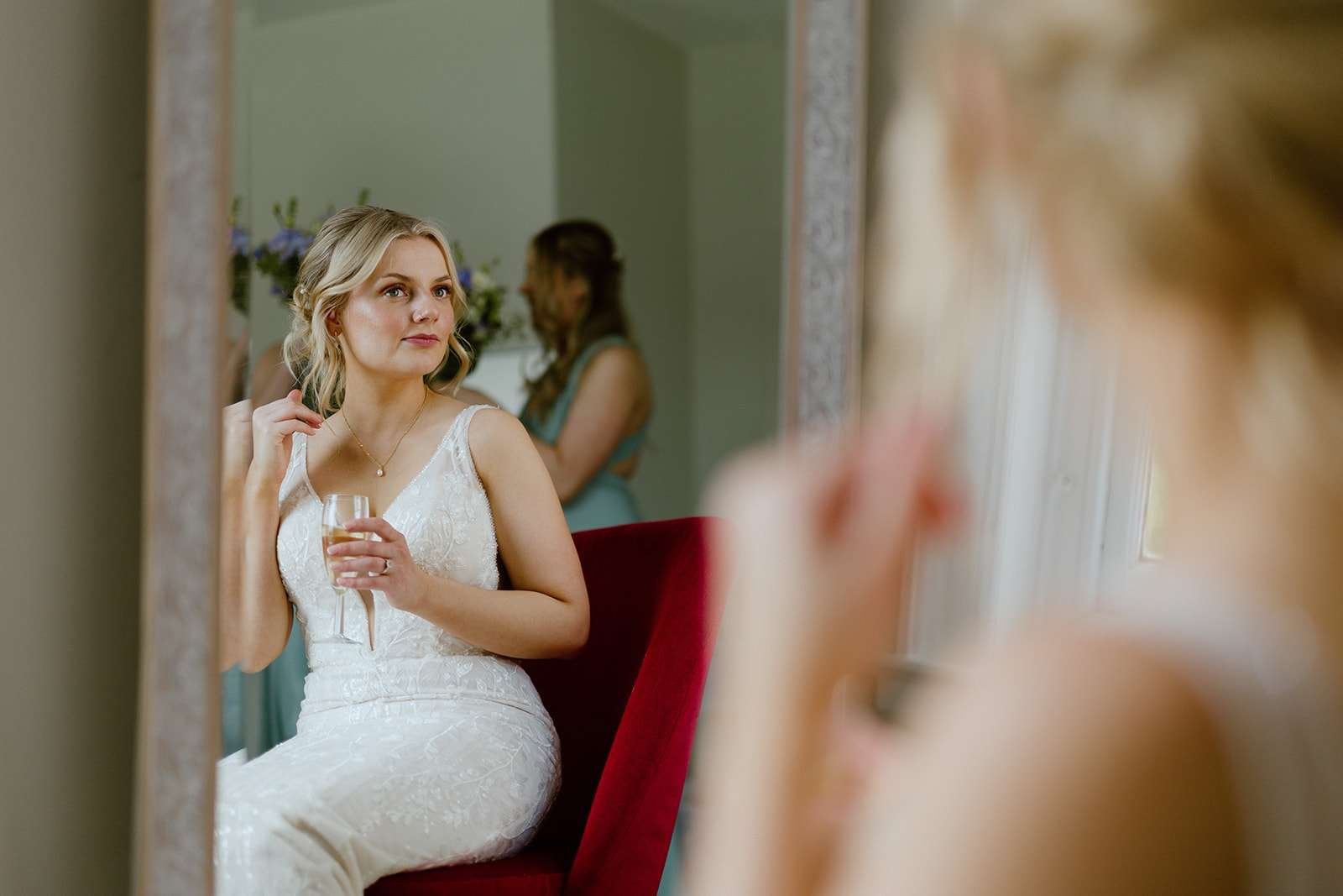 Candid moment of bride getting ready in the Verey Room – soft natural light wedding prep at Antrobus House.