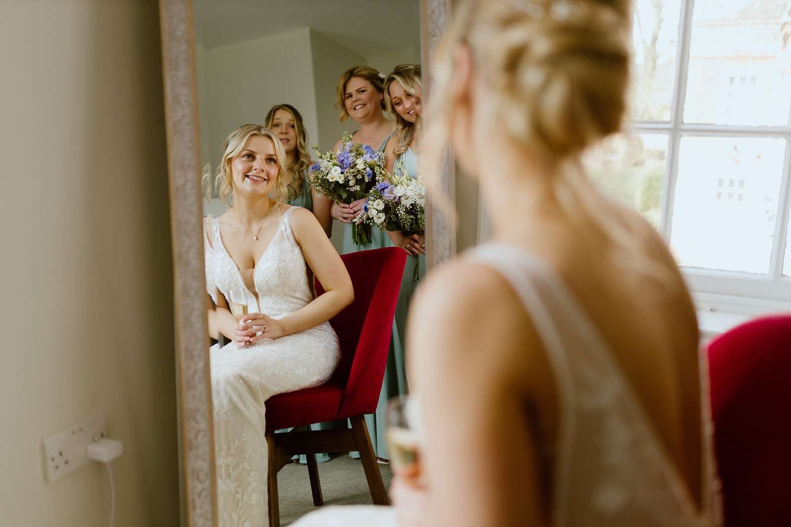 Candid moment of bride getting ready in the Verey Room – soft natural light wedding prep at Antrobus House.