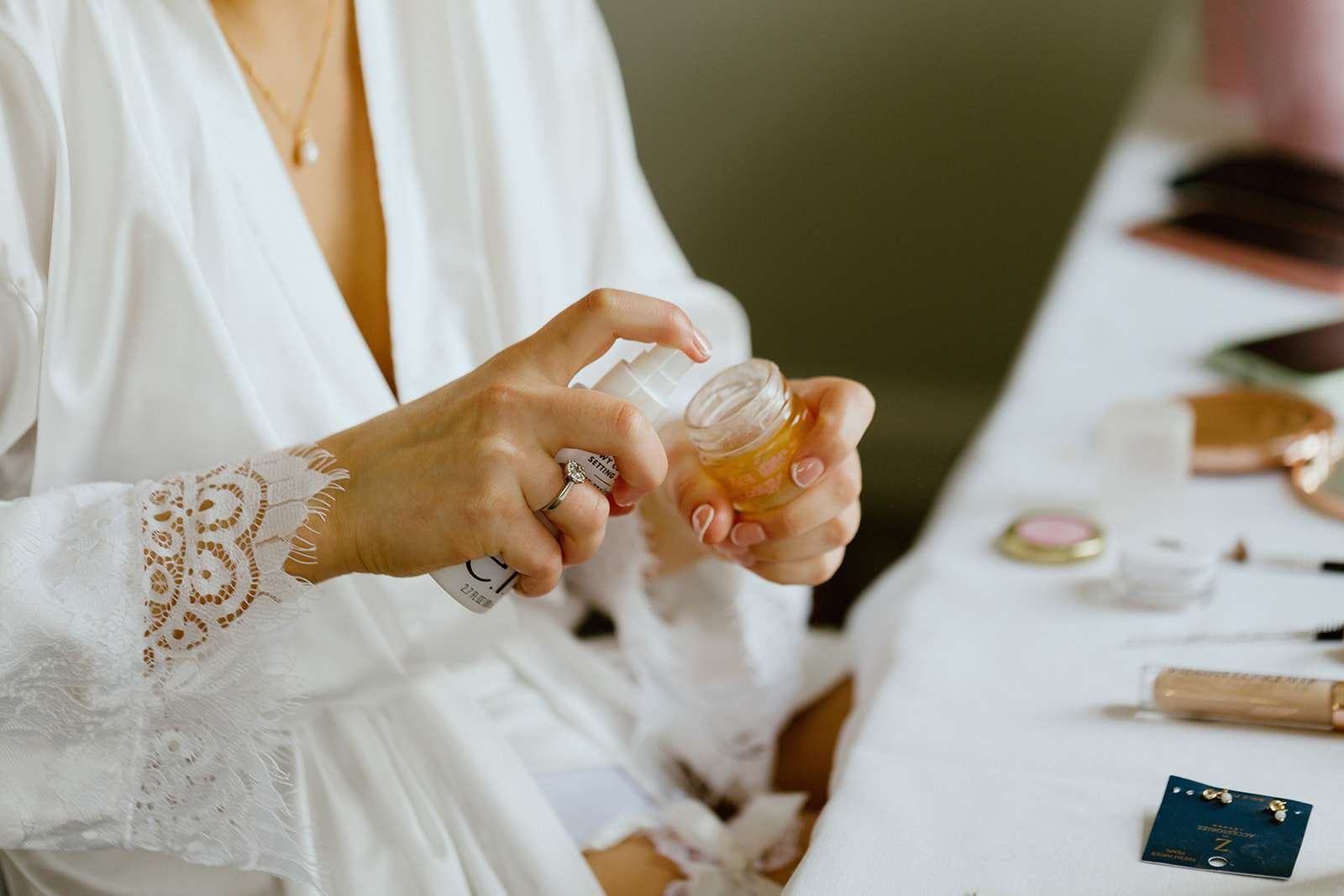 Candid moment of bride getting ready in the Verey Room  at Antrobus House.