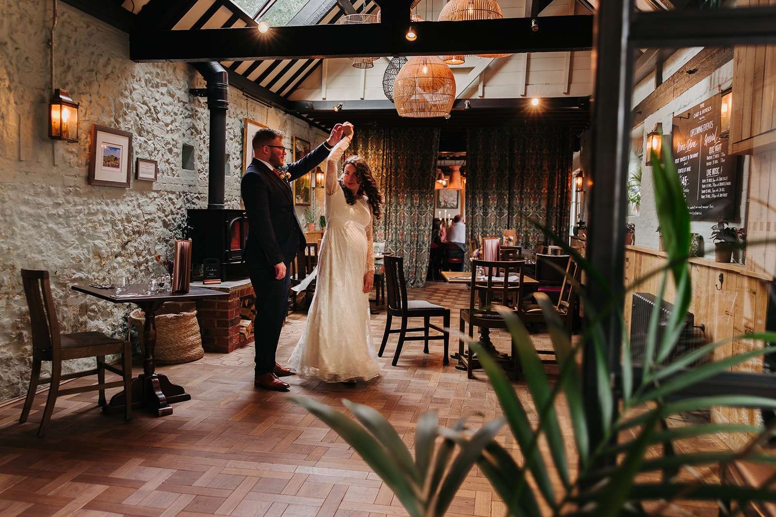 Bride and groom enjoying their first dance at The Cart & Horses rustic reception venue.