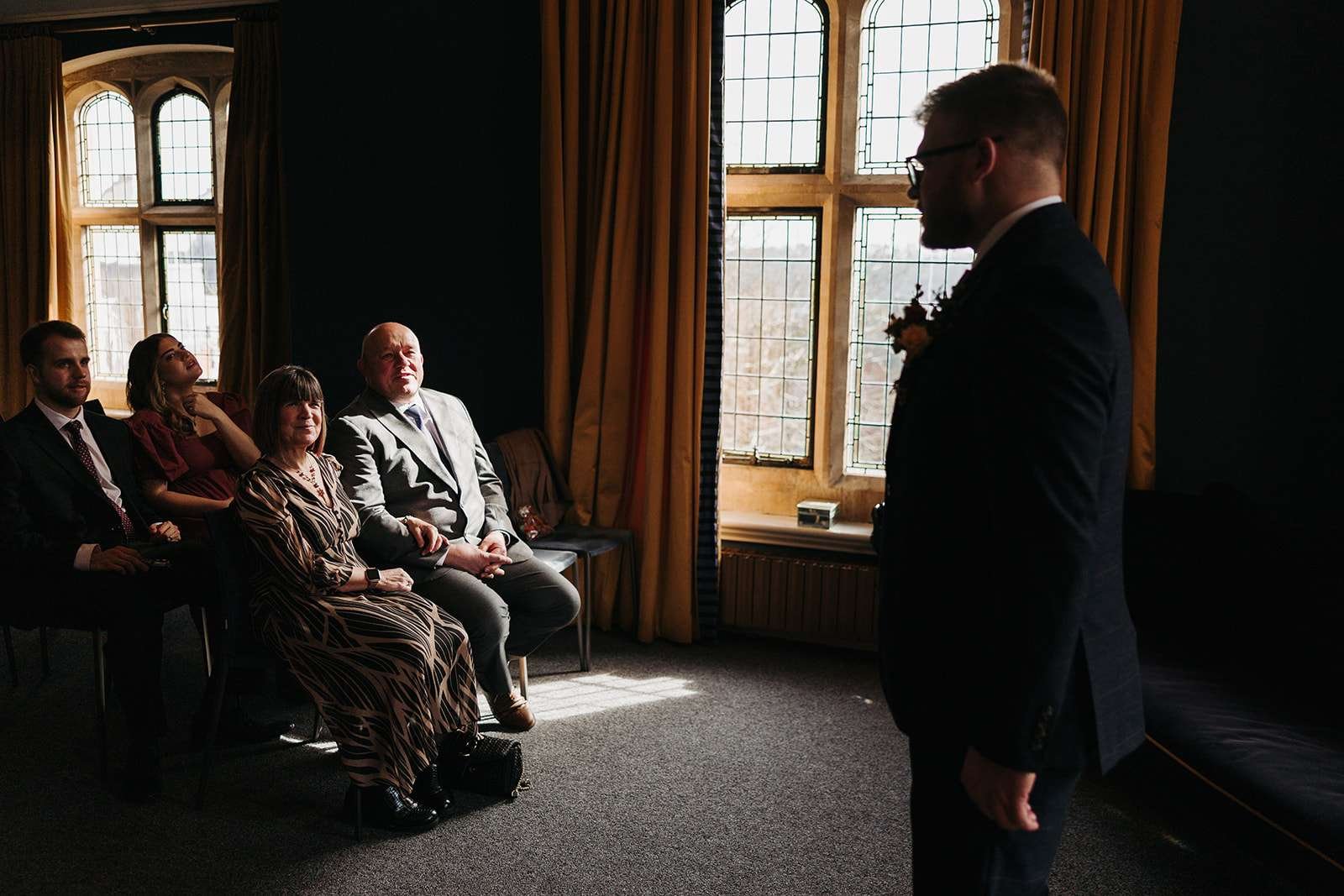 Groom waiting nervously in the Castle Room – Winchester wedding videographer candid moment.