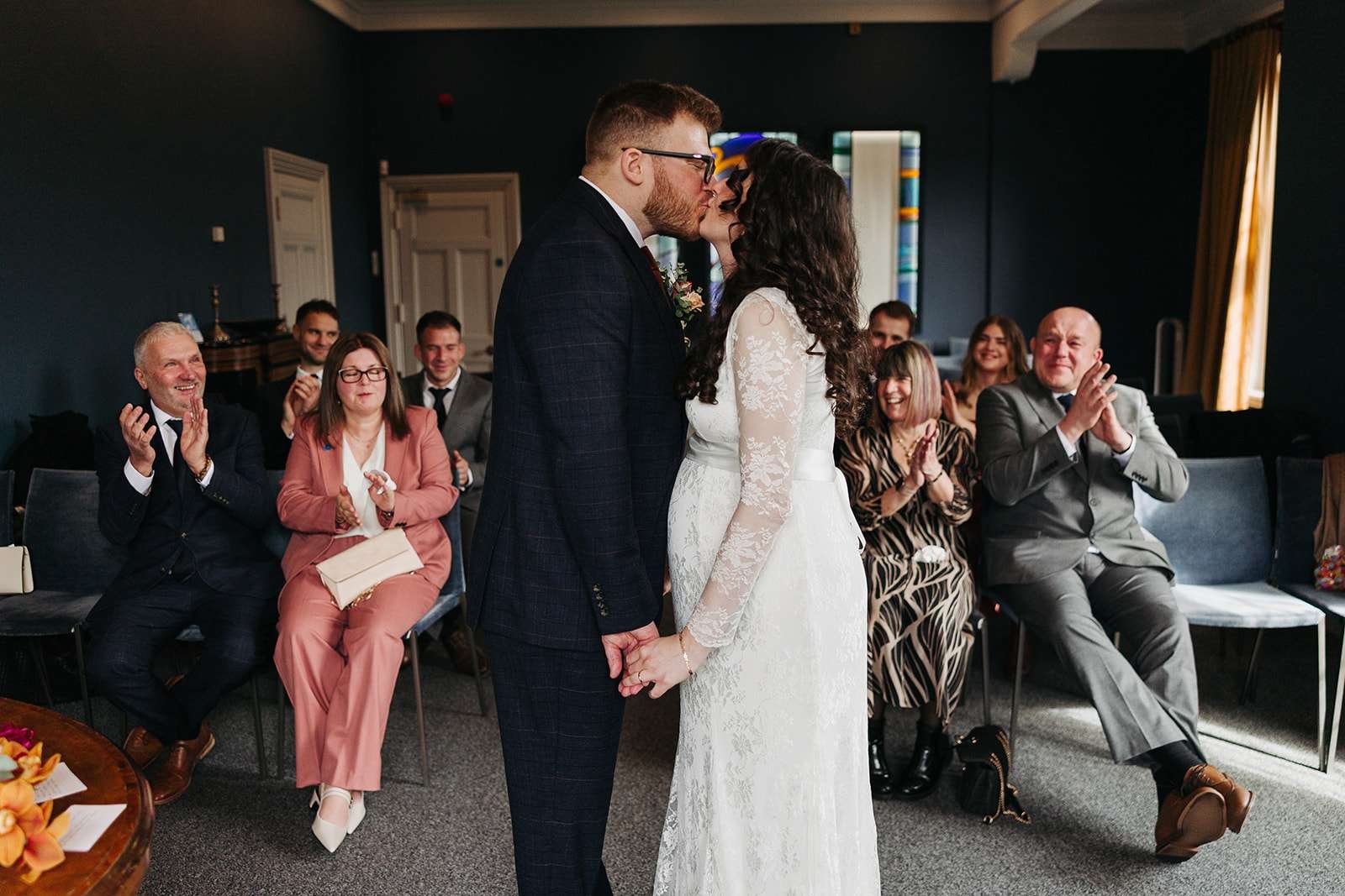 Bride and groom sharing a kiss inside Winchester Registry Office after their wedding ceremony.