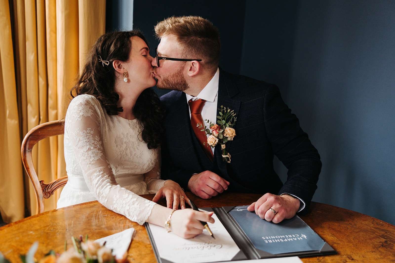 Bride and groom sharing kisses at a Winchester Registry Office ceremony
