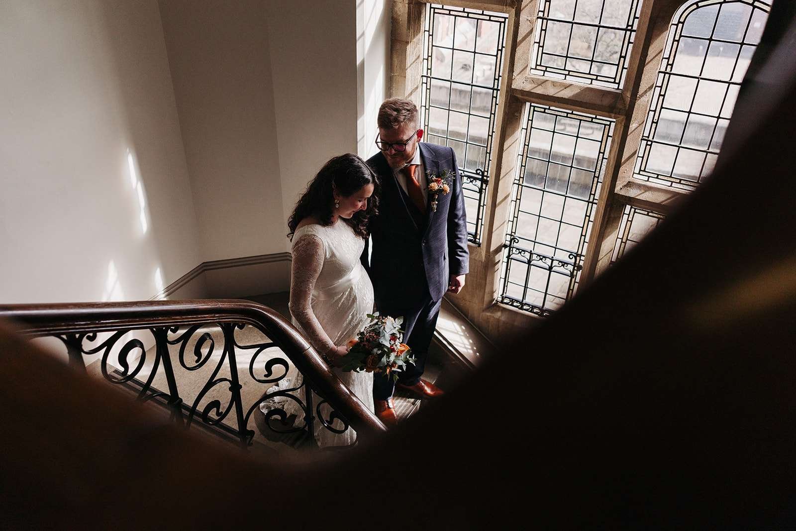 Bride and groom wedding photos: ceremonial staircase at Winchester registry office