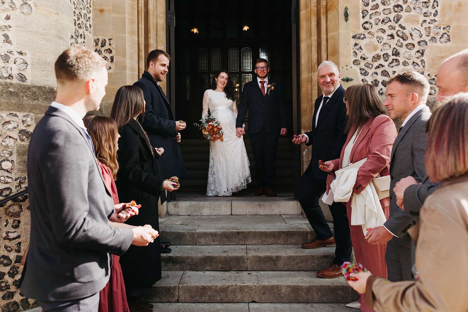 Just married couple sharing a quiet moment outside Winchester Registry Office photo by Winchester wedding photographer