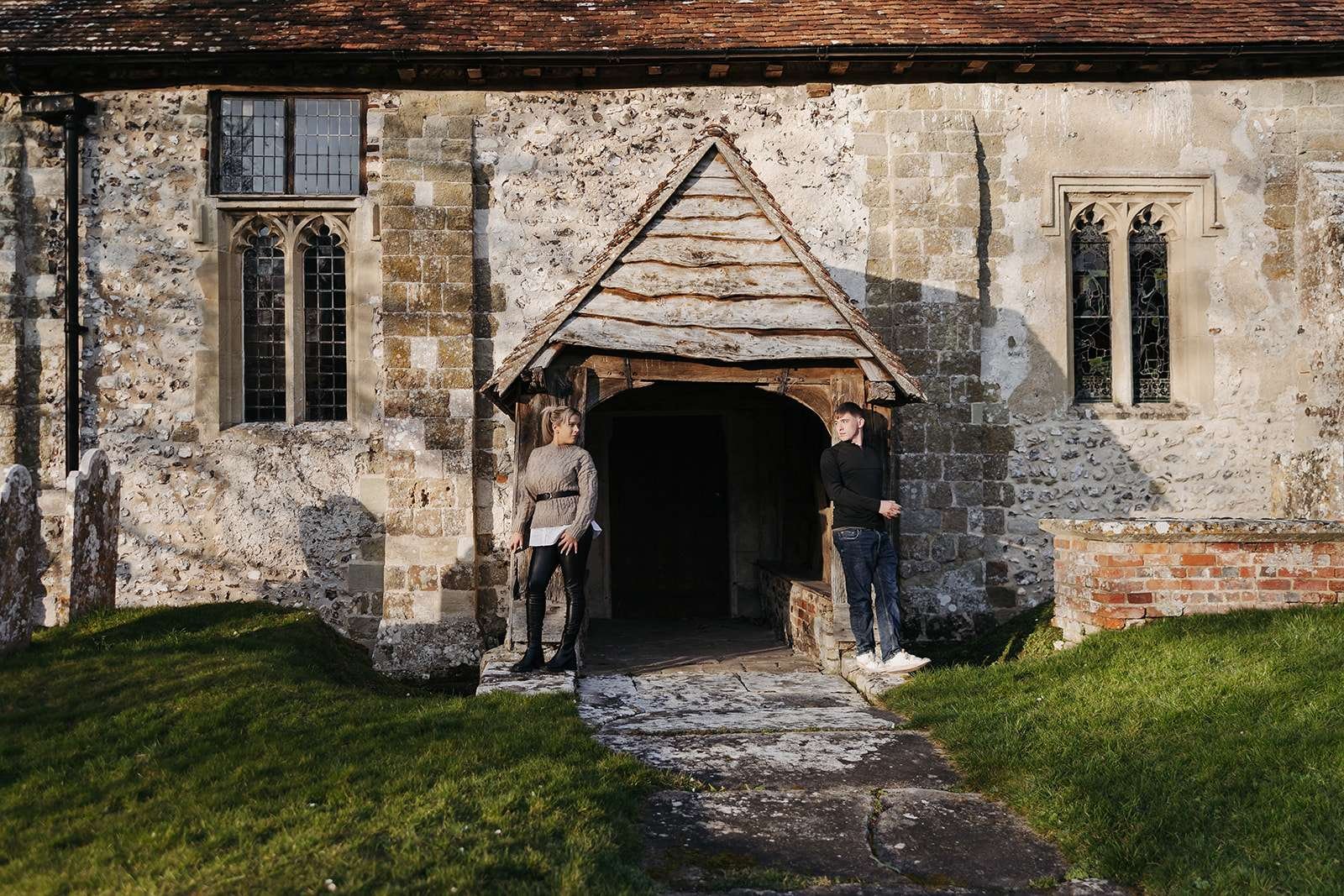 Intimate couple moment at golden hour, with Salisbury’s historic church in the background.