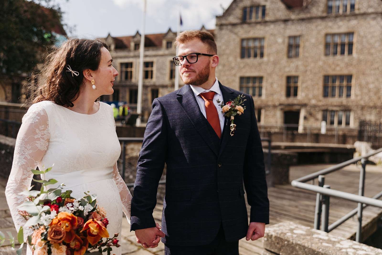 Just married couple sharing a quiet moment outside Winchester Registry Office photo by Winchester wedding photographer